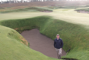 Seth stands in the fairway bunker on No. 18 at Chambers Bay. Photo by Josh Lewis