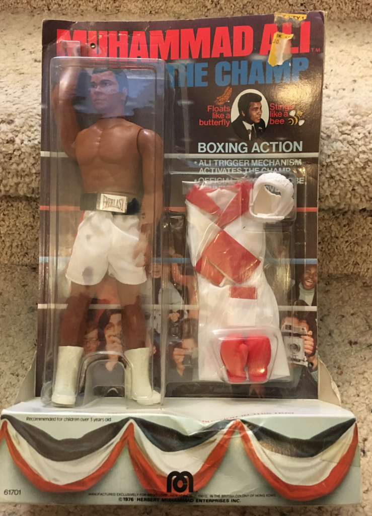 I have a few interesting pieces of Ali memorabilia. Each of these has a special place in my collection (90% of my collection consists of comic books… about 4,500 comics in all.) This Ali Mego toy is from 1976, still unopened in the box. This was my Mom’s, she collected toys before I was born, and passed them on to me. I always thought this was the single coolest toy Mom gave me. 