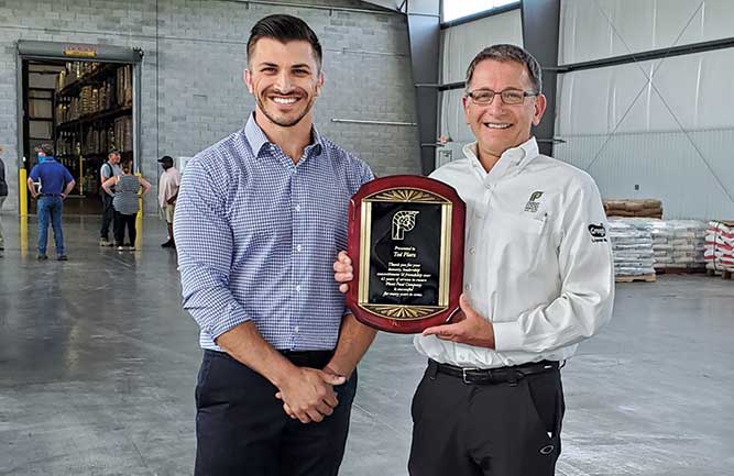 Vice President Grant Platz (left) and President Ted Platz commemorate Plant Food Co.’s 75th anniversary in 2021. (Photo courtesy of Plant Food Co.)