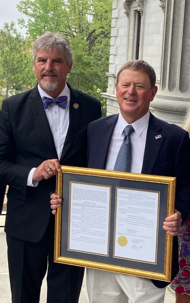 SC Rep. Roger Kirby with Chuck Green and the resolution honoring his golf course superintendent career Photo: